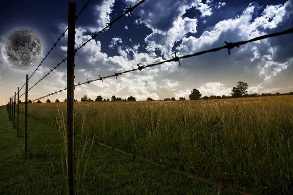 Nuvens no céu e cerca de agricultores no campo — Fotografia de Stock