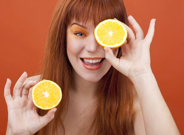 Redhead girl with orange — Stock Photo, Image