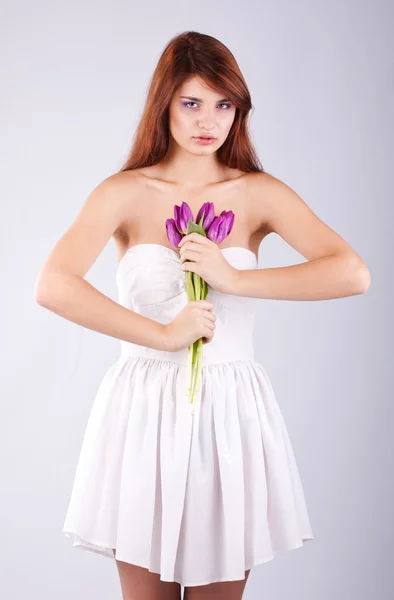 Belle fille avec un bouquet de fleurs de printemps — Photo