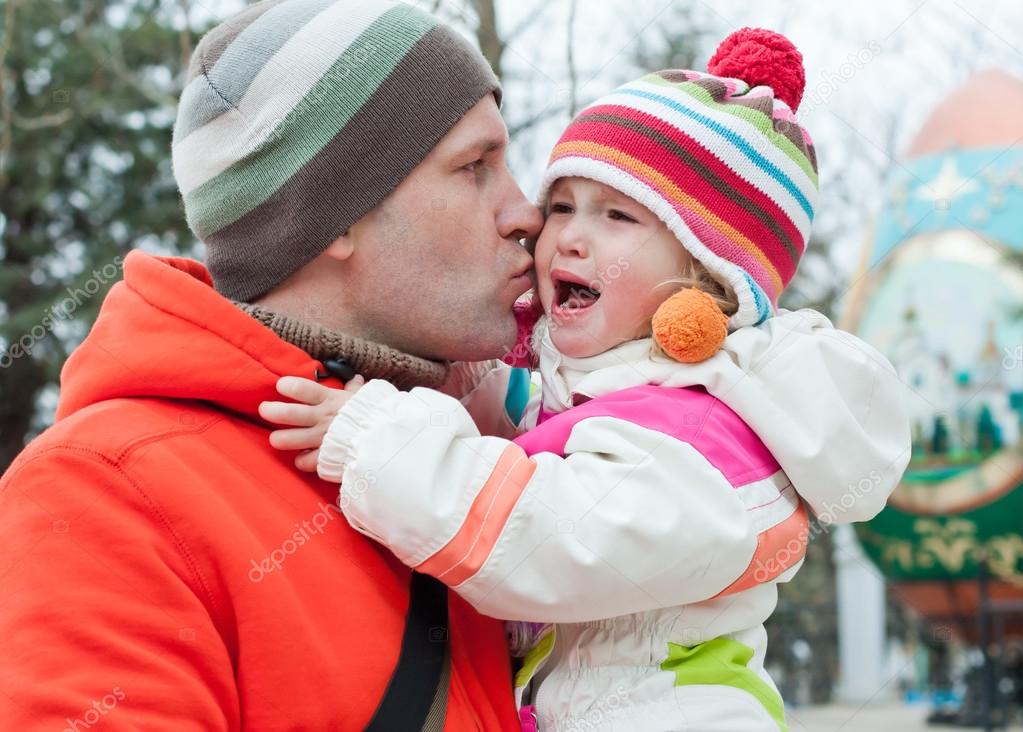 Dad kissing daughter