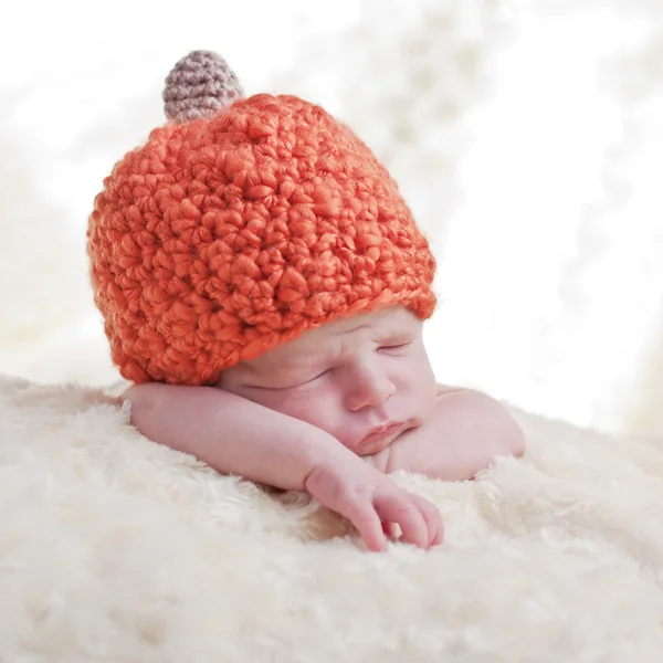 Newborn in a cap pumpkin — Stock Photo, Image