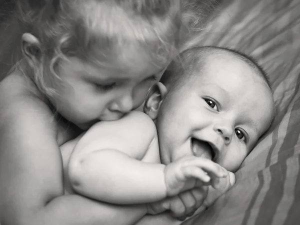 Happy little girl hugging kissing brother — Stock Photo, Image