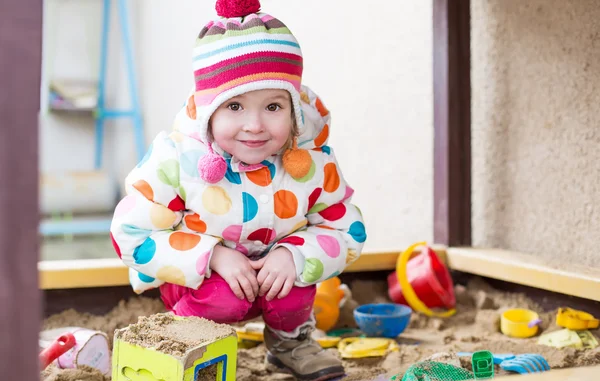 Cute little girl in a sandbox — Stock Photo, Image