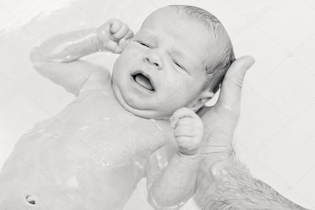 first bathing newborn baby