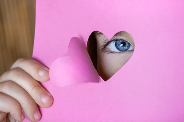 Child looking through a heart shape card — Stockfoto