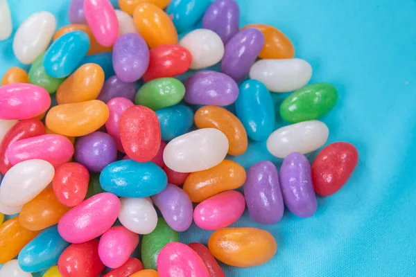 Various Jelly Beans Blue Background — Stock Photo, Image