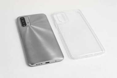 İzole edilmiş beyaz arkaplan üzerinde şeffaf kapaklı yeni cep telefonu