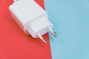 Şarj aleti ve USB kablo tipi C pembe ve mavi arkaplan üzerinde