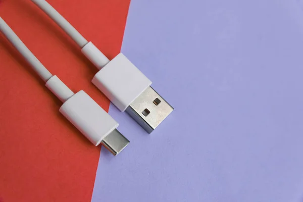 USB cable type C over pink and blue background