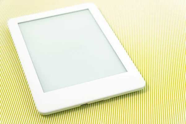 Ebook reader over green striped background