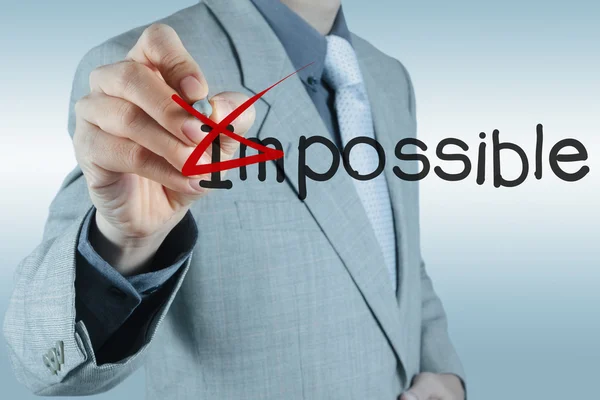 Businessman changing the word impossible into possible — Stock Photo, Image