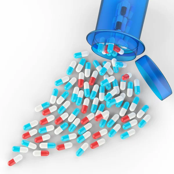 Píldoras que se derraman de la botella de la píldora en blanco — Foto de Stock