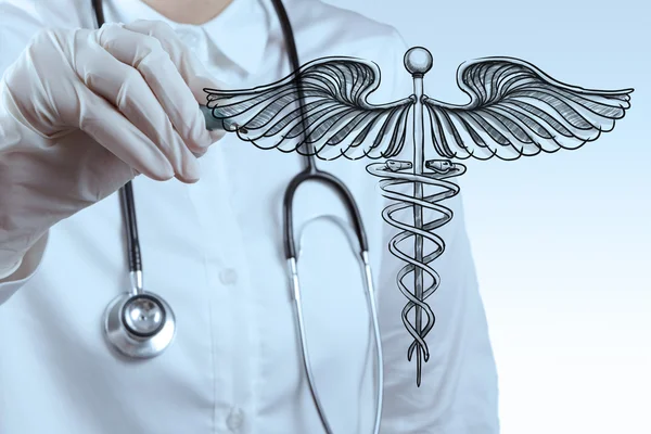 Doctor draws Caduceus on white board — Stock Photo, Image