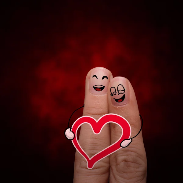 Gelukkig vinger paar in liefde met geschilderde smiley en houden hart — Stockfoto