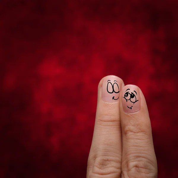 Happy couple in love with painted smiley and hugging — Stock Photo, Image