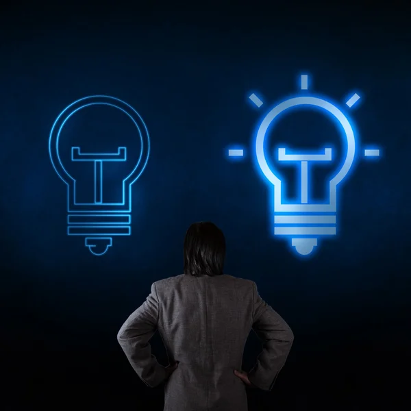 Light bulb and a business person as symbols of creativity — Stock Photo, Image