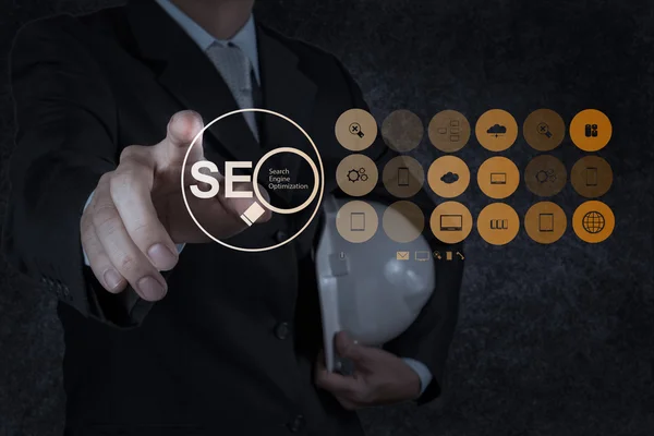 Business man hand showing search engine optimization SEO — стоковое фото