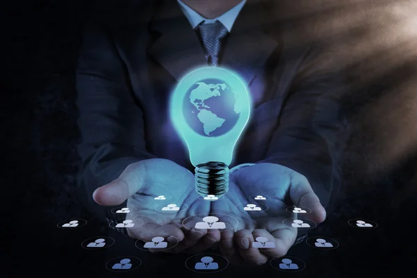 Businessman hand shows Light bulb with planet Earth — Stock Photo, Image