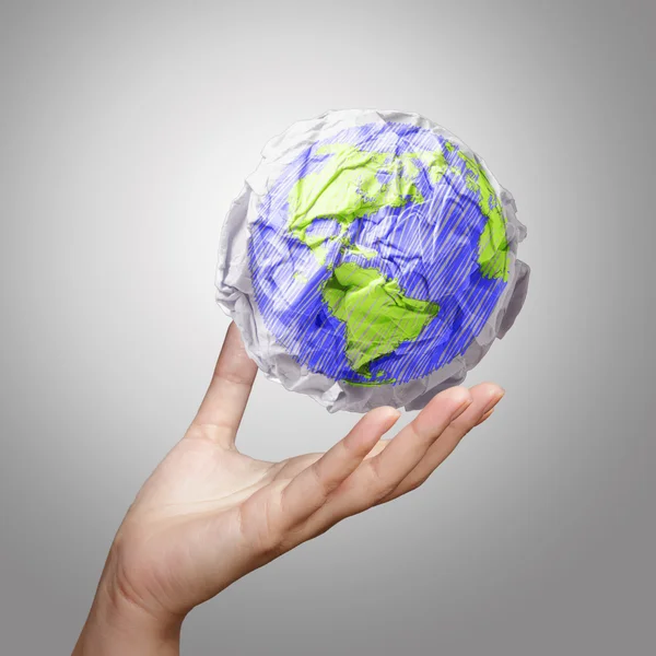 Hand showing crumpled world paper symbol — Stock Photo, Image