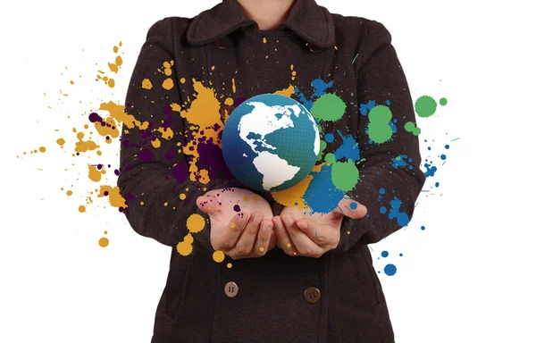 Businesswoman shows the earth and splash colors — Stock Photo, Image