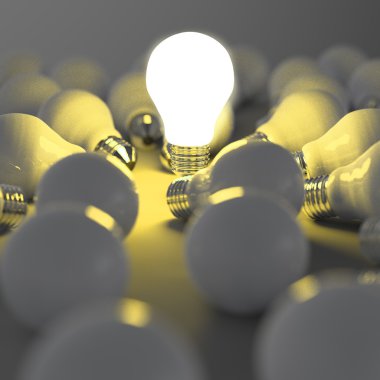 growing light bulb standing out from the unlit incandescent bulb clipart