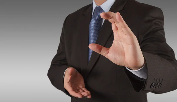 Businessman pressing an imaginary button on virtual screen — Stock Photo, Image