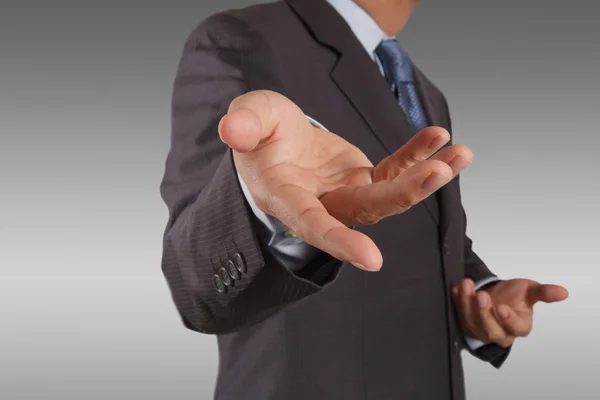 Business man with an open hand as showing something — Stock Photo, Image