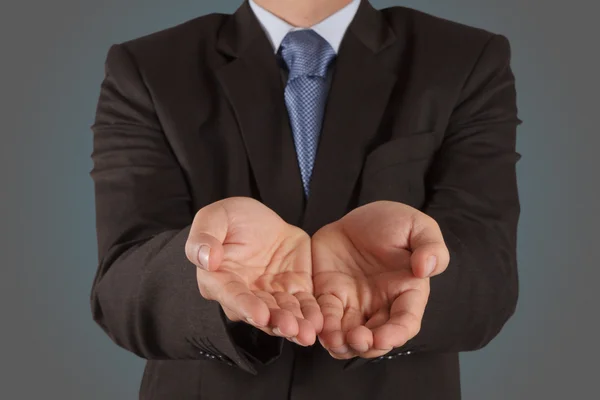 Business man with an open hand as showing something — Stock Photo, Image