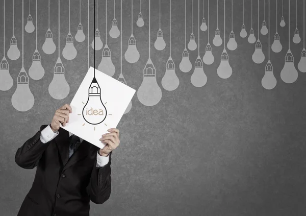 Businessman showing the book of drawing idea light bulb concept — Stock Photo, Image