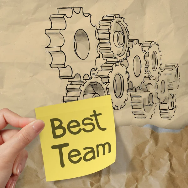 Hand hold sticky note with best team word with gear to success — Stock Photo, Image