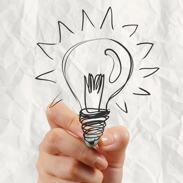 Hand drawing light bulb with crumpled paper — Stock Photo, Image