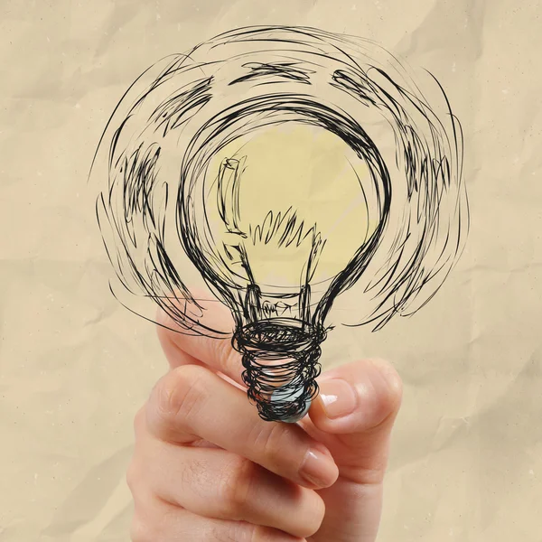 Hand drawing light bulb with crumpled paper — Stock Photo, Image