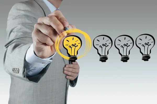 Businessman hand drawing light bulb as creative concept — Stock Photo, Image