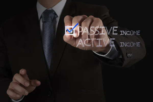 Businessman hand checking passive or acctive income as money co — Stock Photo, Image