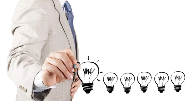 Business man hand drawing idea light bulb as concept — Stock Photo, Image