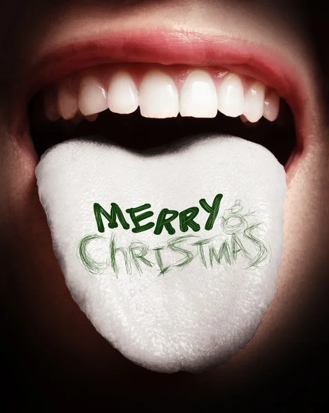 Woman with open mouth spreading tongue colored in merry christma — Stock Photo, Image