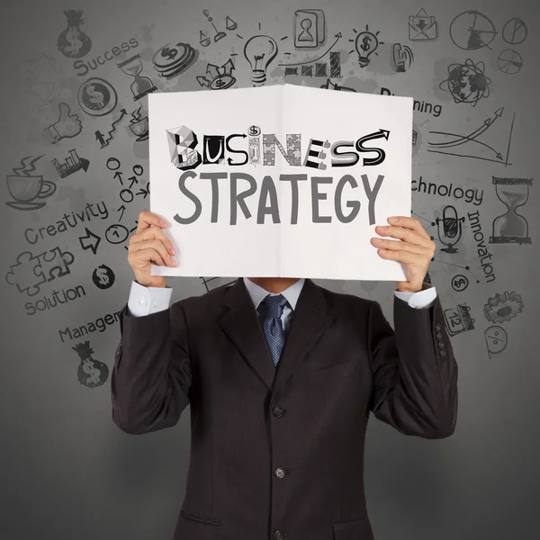 ビジネスマン手概念としてのビジネス戦略の本を示す — ストック写真