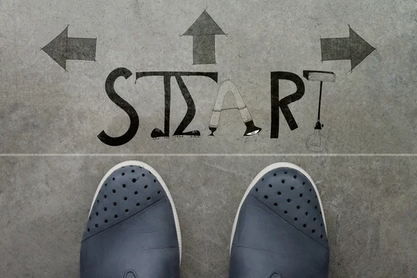 A pair of feet on cement floor — Stock Photo, Image