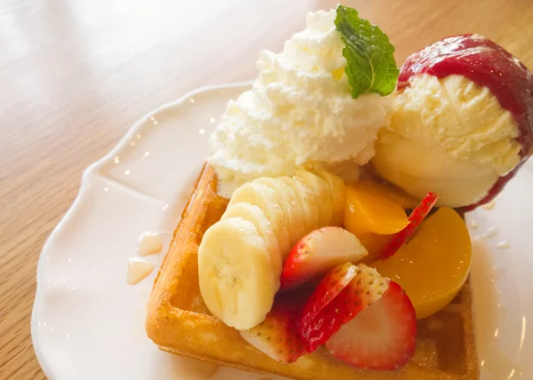 Waffle with fruits on wooden table — Stock Photo, Image