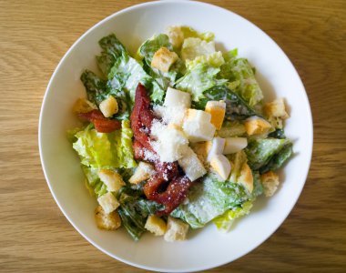  Sezar salatası ahşap bir masa üzerine yerleştirilen