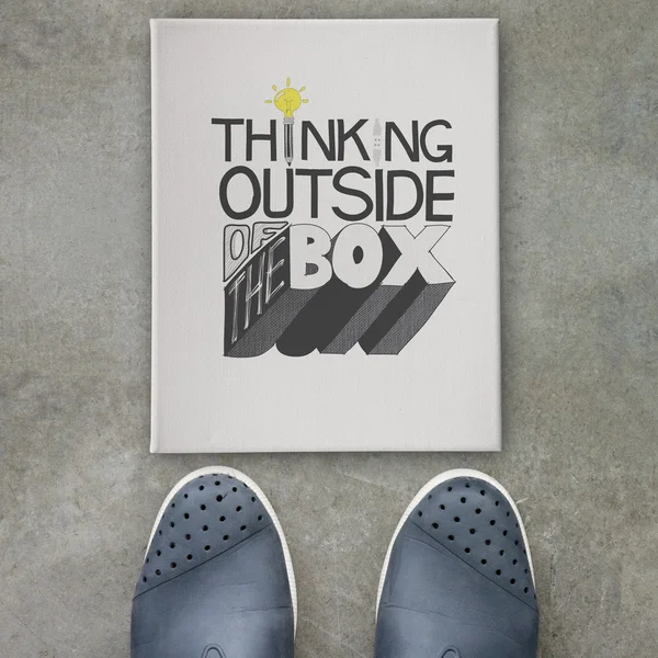 Design word THINKING OUTSIDE OF THE BOX  on canvas board on fro — Stock Photo, Image