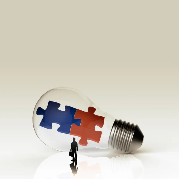 Light bulb and two puzzles with businessman as partnership conce — Stock Photo, Image