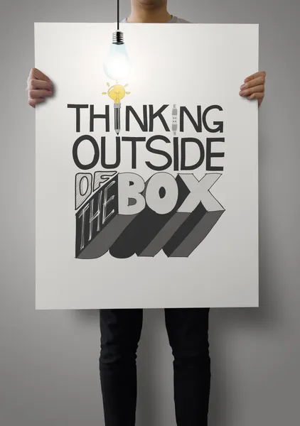 Man showing poster of hand drawn  word THINKING OUTSIDE OF THE B — Stock Photo, Image