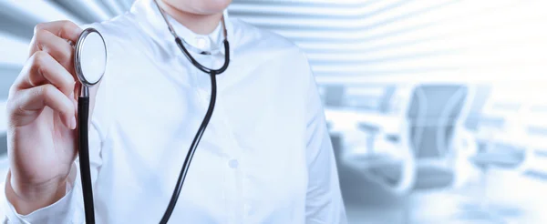 Doctor with a stethoscope in the hands and office background — Stock Photo, Image