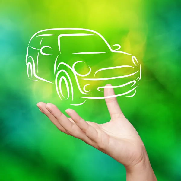 Hand with car against green nature sky background as concept — Stock Photo, Image