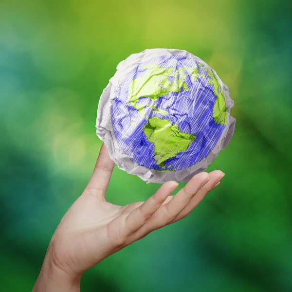 Hand showing crumpled world paper symbol as concept — Stock Photo, Image