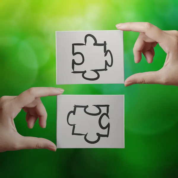 Ruka držící ikona ruky koncipovaného partnerství puzzle na desce cavas — Stock fotografie