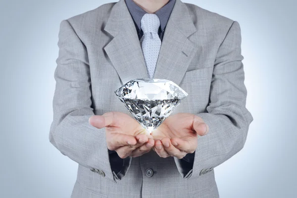 Business man hand holding 3d diamond as concept — стоковое фото