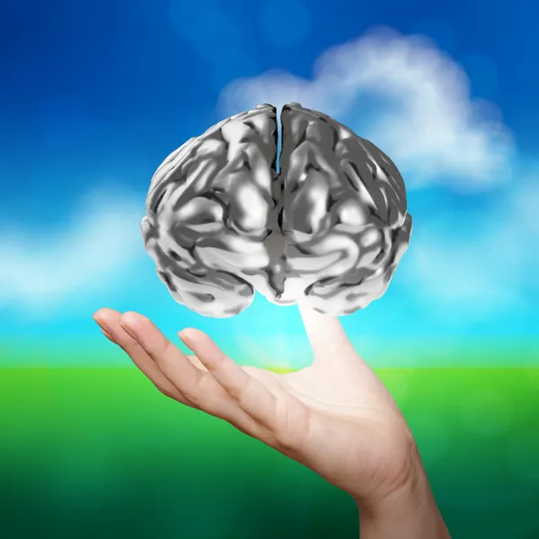 Business man hand showing 3d metal human brain on nature backgrou — стоковое фото