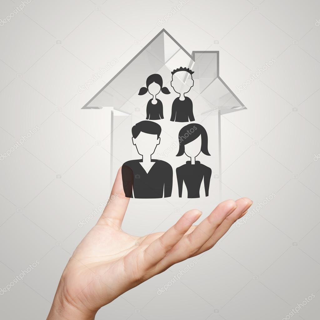 businessman hand holding 3d house with family icon on nature bac